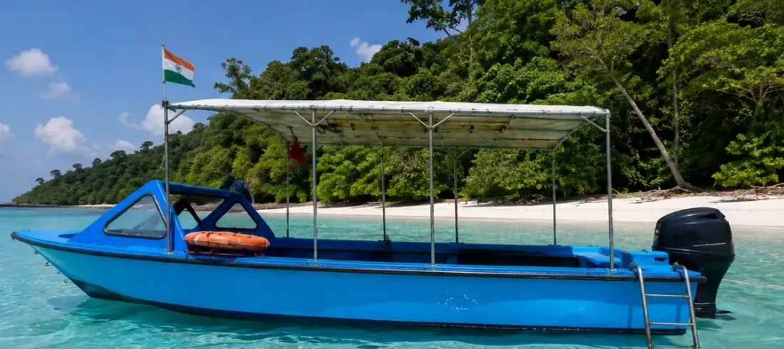 Dive boat anchored off a Havelock beach in the Andaman Islands, where shore dives and boat dives both start