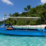 Dive boat anchored off a Havelock beach in the Andaman Islands, where shore dives and boat dives both start