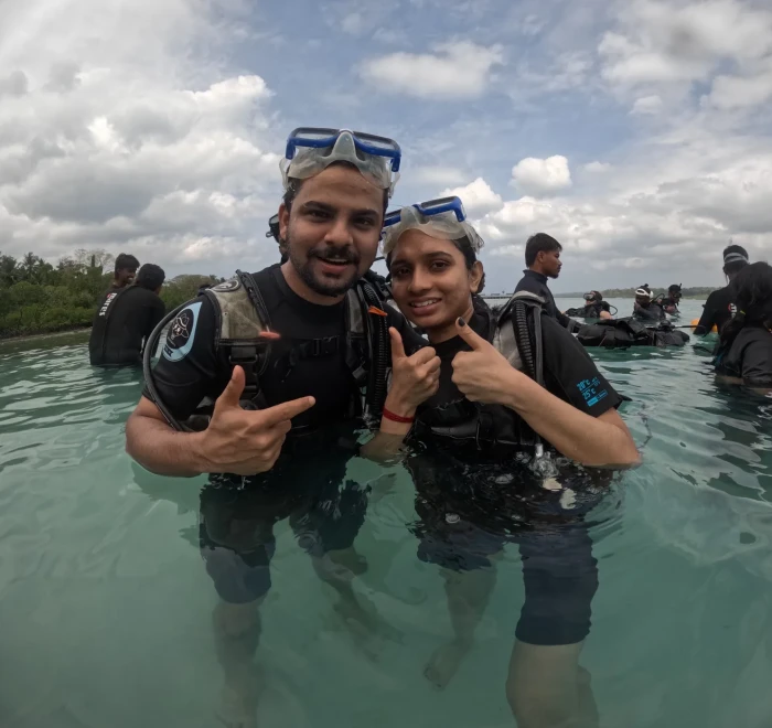 Couple giving shaka signs in the shallows at Havelock