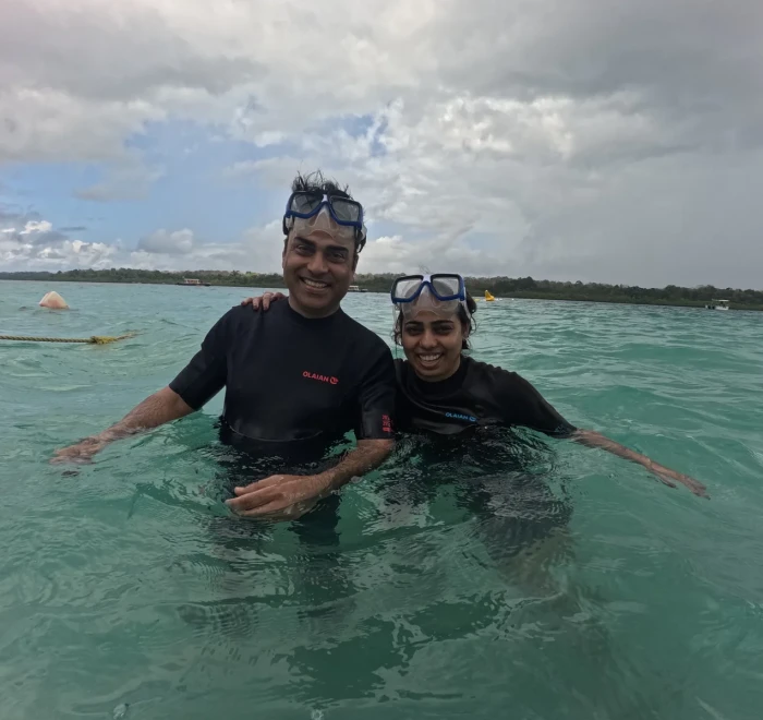 Couple in the shallows before their dive on a cloudy day