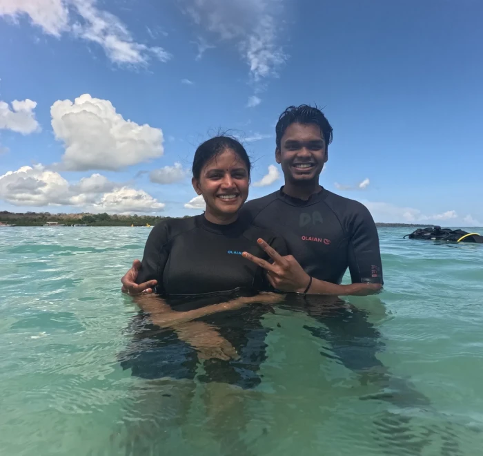 Couple in the shallows giving a peace sign