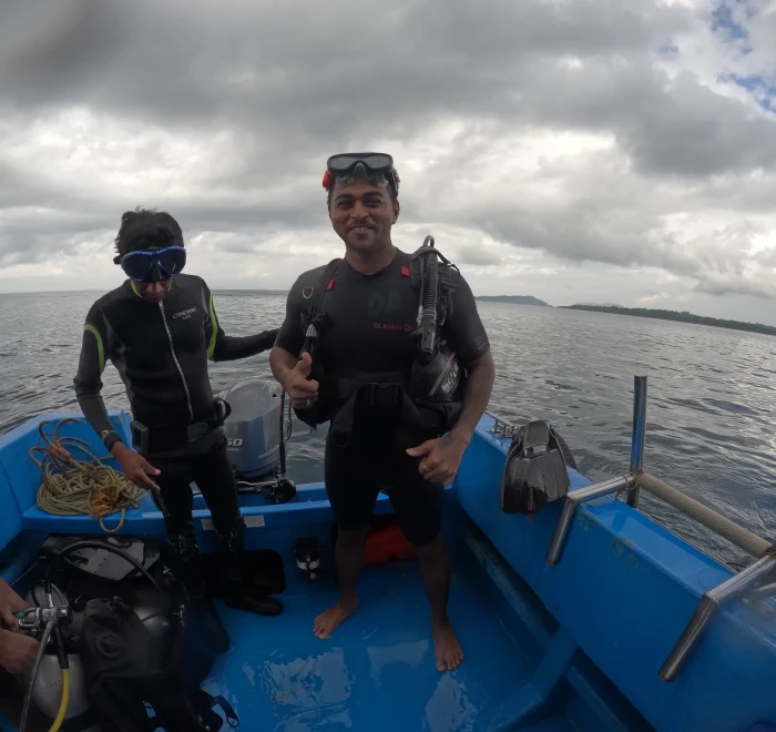 Crew on the dive boat under a cloudy sky