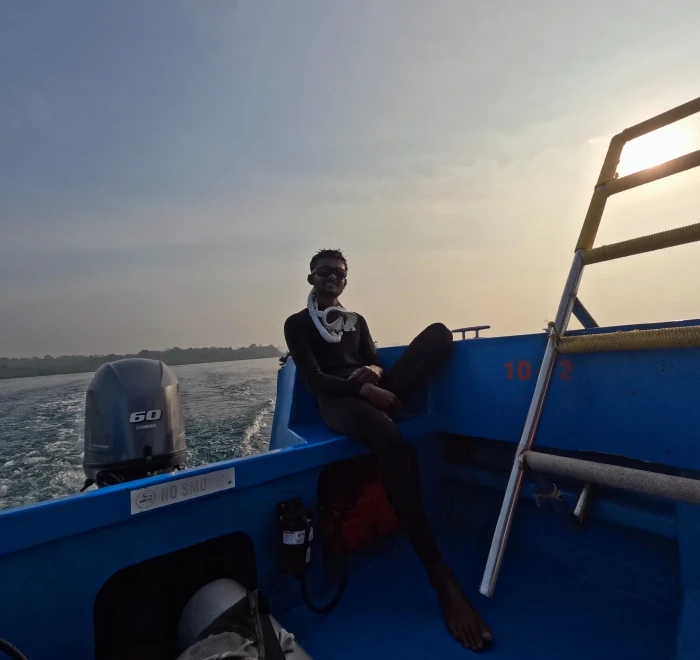 Crew member on the dive boat at dusk off Havelock