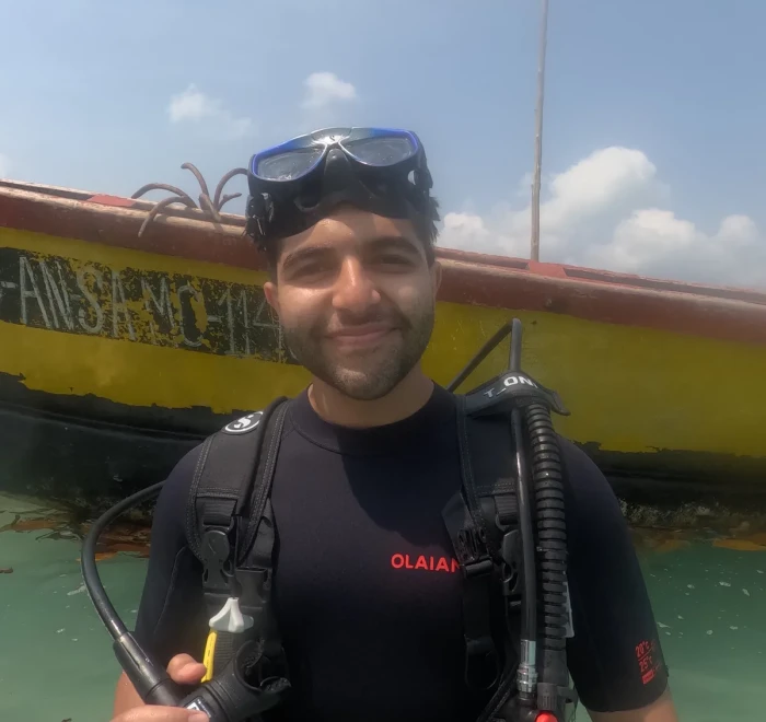 Diver on the boat with the Indian flag flying at the stern