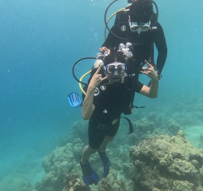 Diver with a camera swimming above the reef