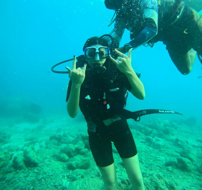 Diver giving the OK sign in green water