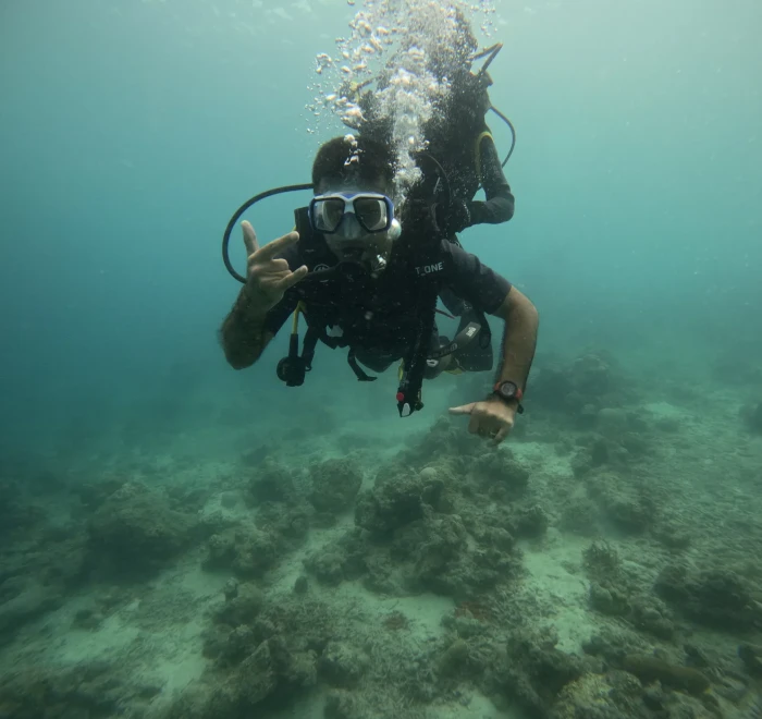 Diver giving the OK sign with the guide close behind