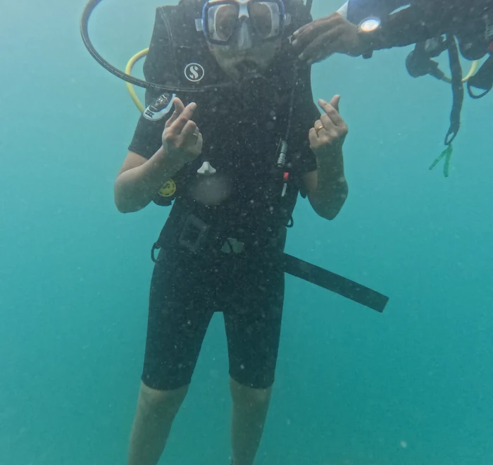 Diver giving OK signs with the instructor behind