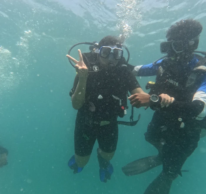 Diver giving a shaka sign near the surface