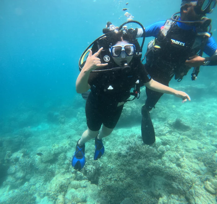 Divers crossing a shallow turquoise reef off Havelock Island