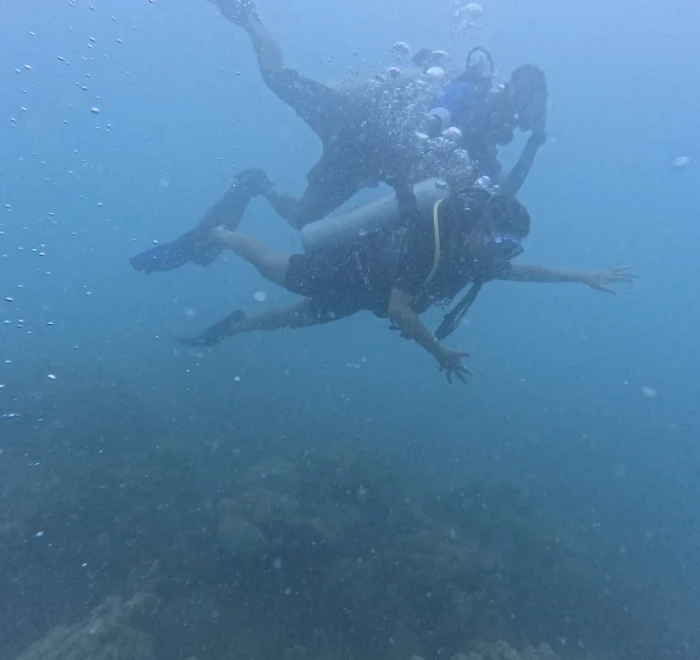 Divers together in open blue water