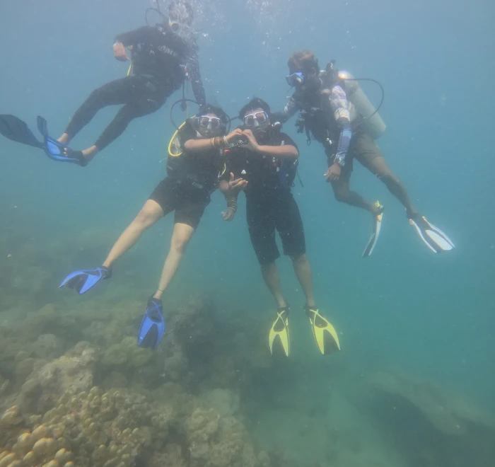 Group of divers together underwater in the shallows