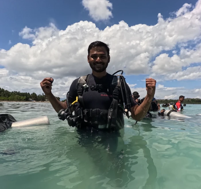 Guest celebrating in the shallows after his dive