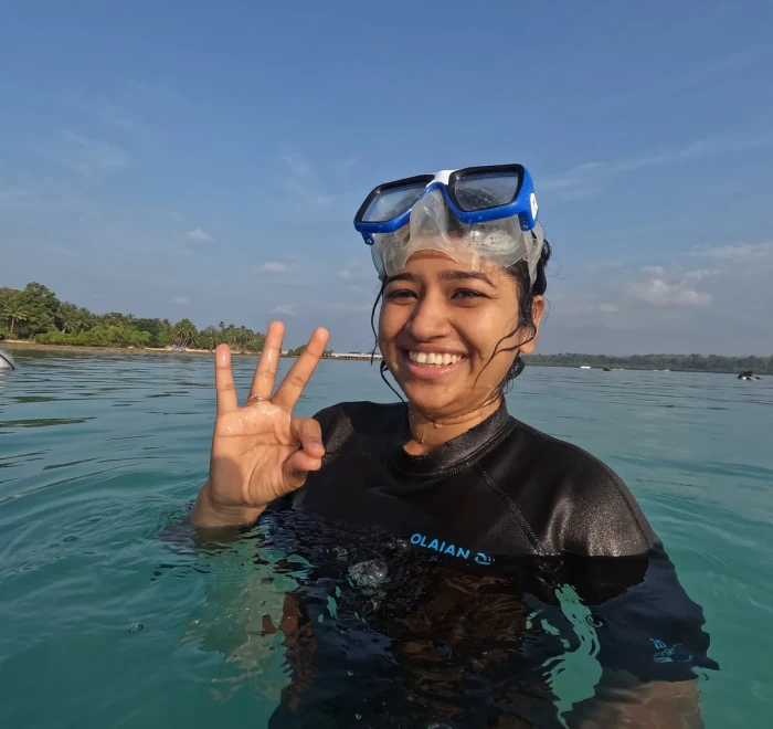 Guest giving the OK sign in the shallows before her first dive