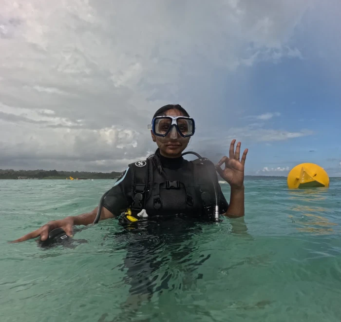 Guest giving the OK sign at the surface beside the buoy