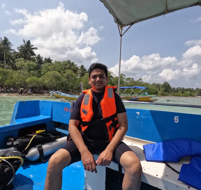 Guest in a life jacket on the dive boat close to shore