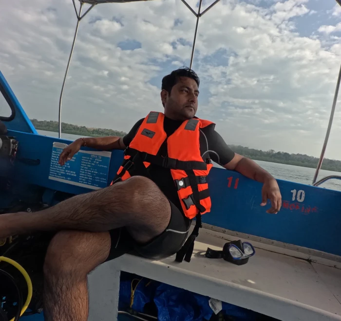 Guest in a life jacket sitting on the dive boat