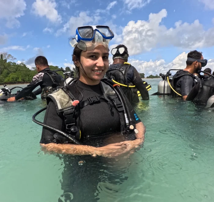Guest in scuba gear standing in the shallows