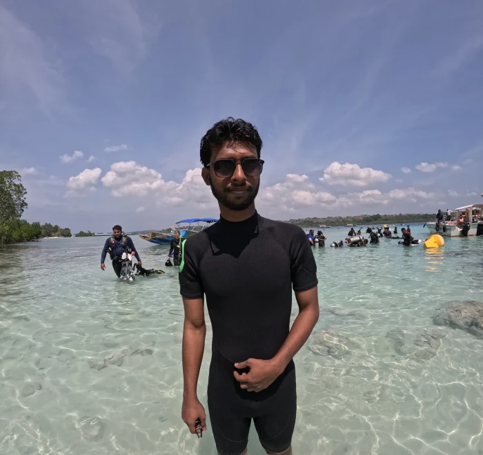 Guest in a wetsuit standing in the shallows at Havelock
