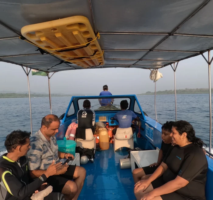 Guests with a cake on the dive boat for a birthday celebration