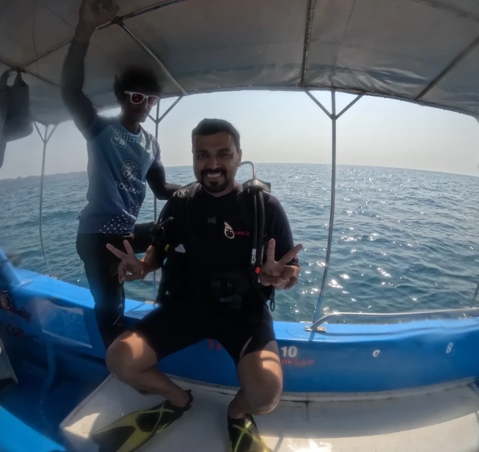 Guests giving peace signs on the dive boat between dives