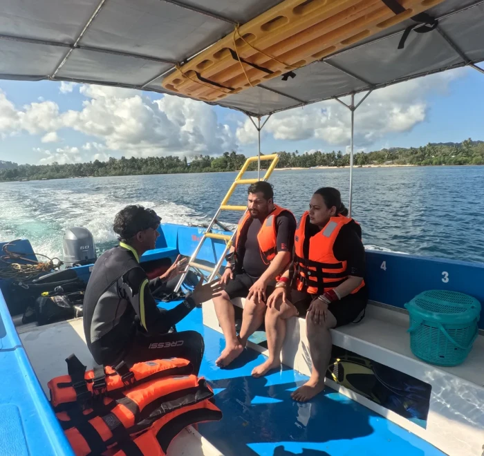Guests in life jackets on the dive boat heading out