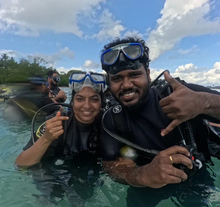 Instructor and guest together in the shallows before a dive