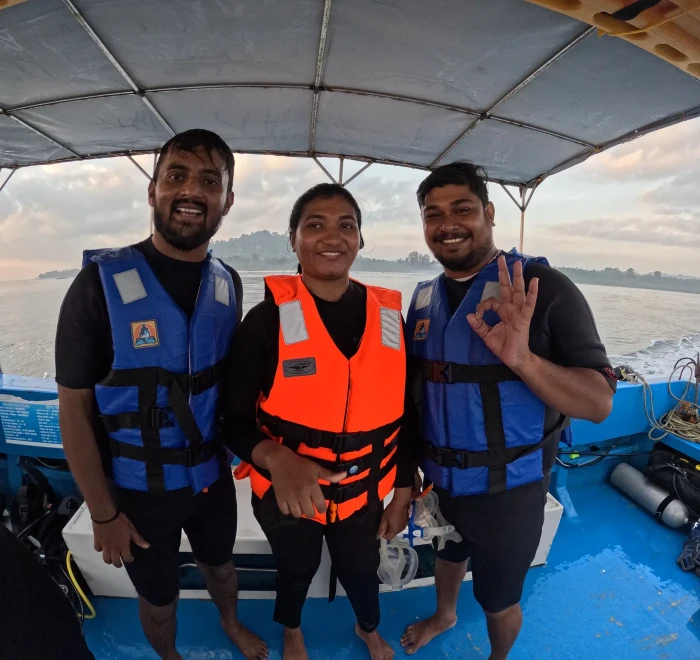 Three guests in life jackets on the Frogman dive boat at the end of the day