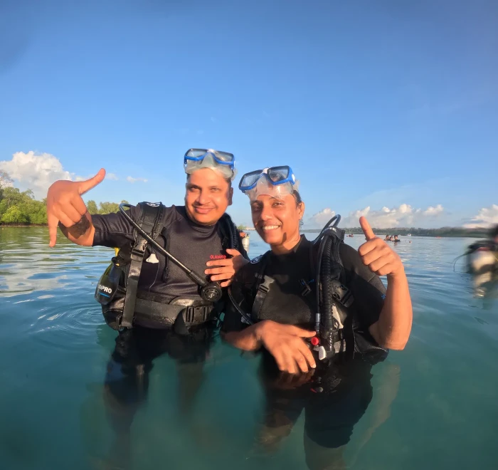 Two beginners in the shallows after finishing a shore dive