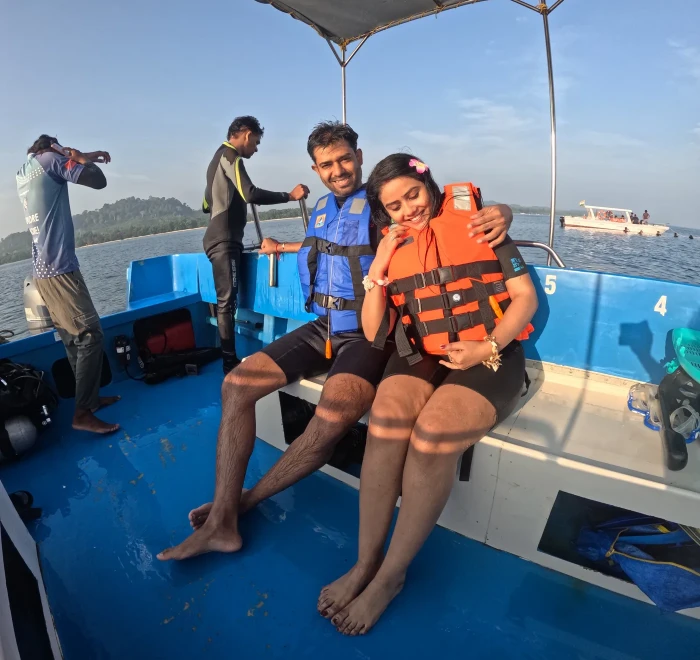 Two guests waiting on the dive boat while the crew sets up the gear