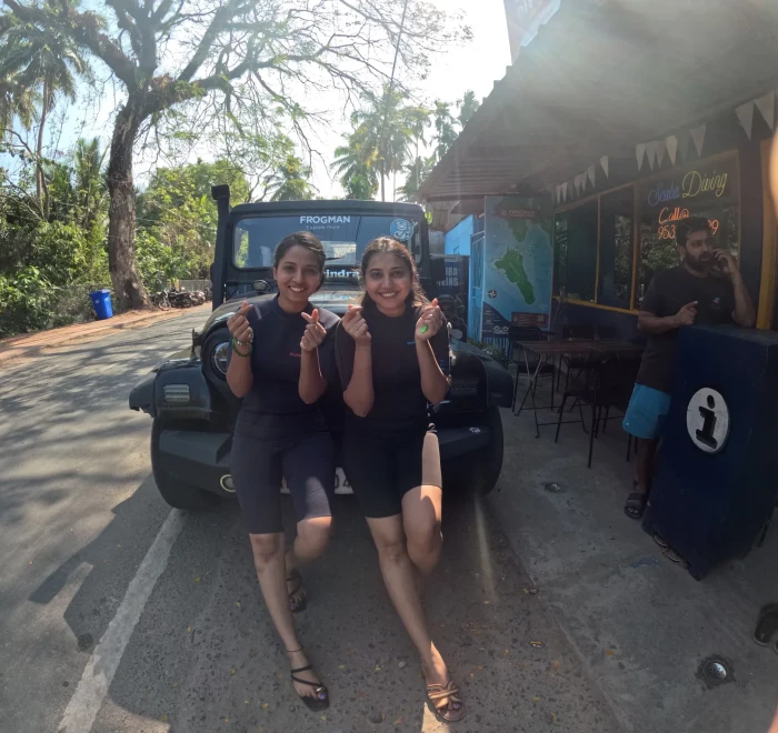 Two guests in wetsuits outside the Frogman dive centre in Havelock