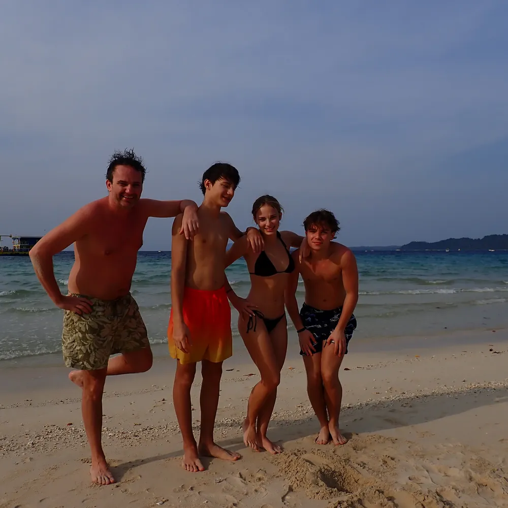 Group of guests on the white-sand beach on a Frogman Cinque Island trip, Andaman