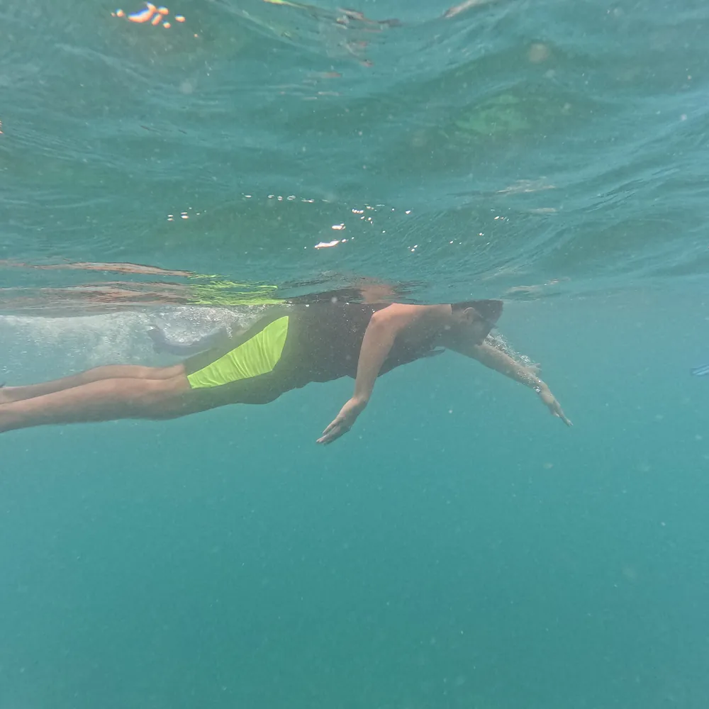 Snorkeller swimming over the shallow reef at Cinque Island, Andaman